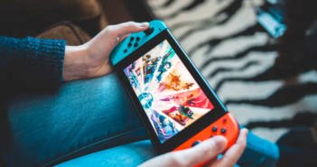 Person holding a red and blue gamepad