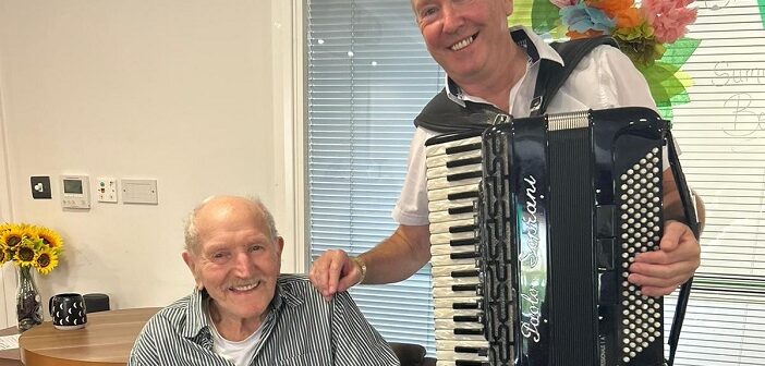 playing his accordion