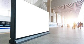 Blank billboard on the railroad station platform.