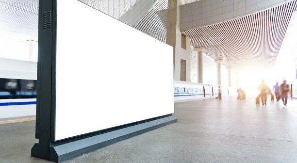 Blank billboard on the railroad station platform.