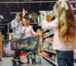children's food allergies A parent checking a food label while shopping with a child