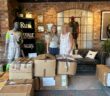 Room at the Inn Fundraising Lead and Volunteer Co-ordinator Morven receives the donation of sportswear from New Balance.