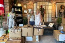 Room at the Inn Fundraising Lead and Volunteer Co-ordinator Morven receives the donation of sportswear from New Balance.