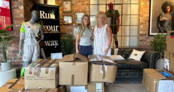 Room at the Inn Fundraising Lead and Volunteer Co-ordinator Morven receives the donation of sportswear from New Balance.