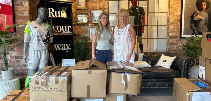 Room at the Inn Fundraising Lead and Volunteer Co-ordinator Morven receives the donation of sportswear from New Balance.