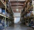 A large warehouse interior with steel racking and pallets Warrington warehouses